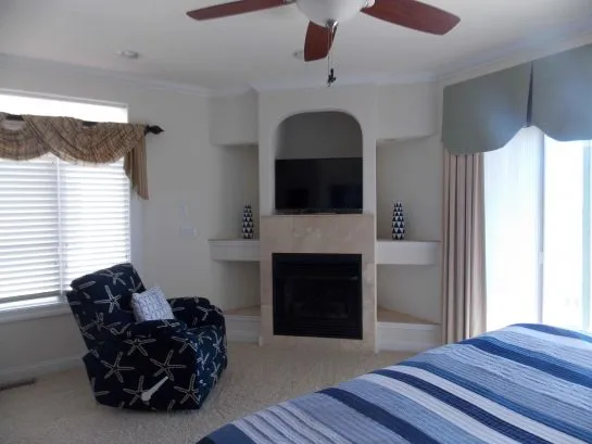 Master fireplace and reading chair (curtains to be changed)