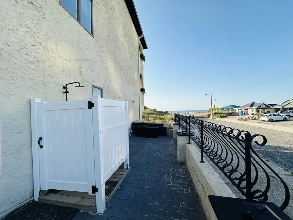 Outdoor shower on gated oceanfront patio