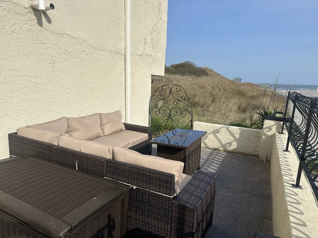 Sectional with fire table on gated oceanfront patio