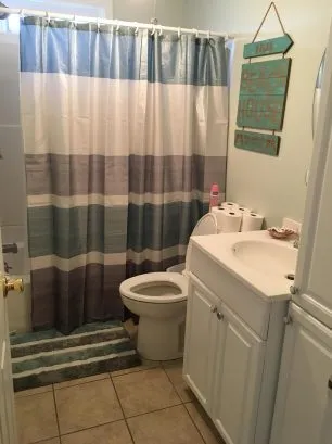 Bathroom has fan and window for natural light in bath/shower.