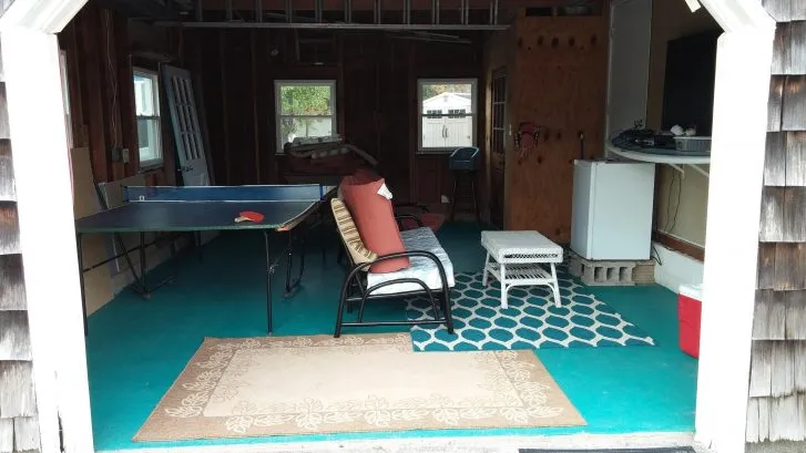 Garage has full size ping pong table, huge flatscreen tv, seating and small fridge