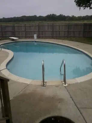 A view of the pool from the back deck. Notice the quiet field behind.