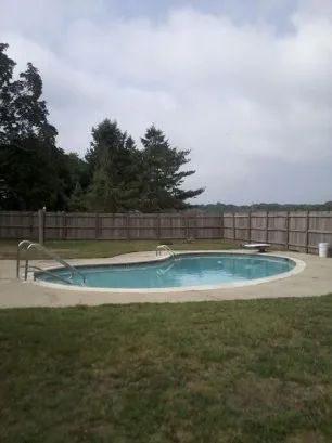 A view of the pool and fenced back yard.