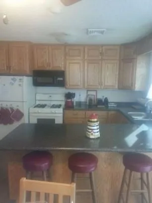The kitchen is furnished with appliances, including a dishwasher