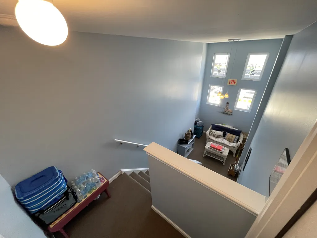 Looking down enclosed steps  to large landing 