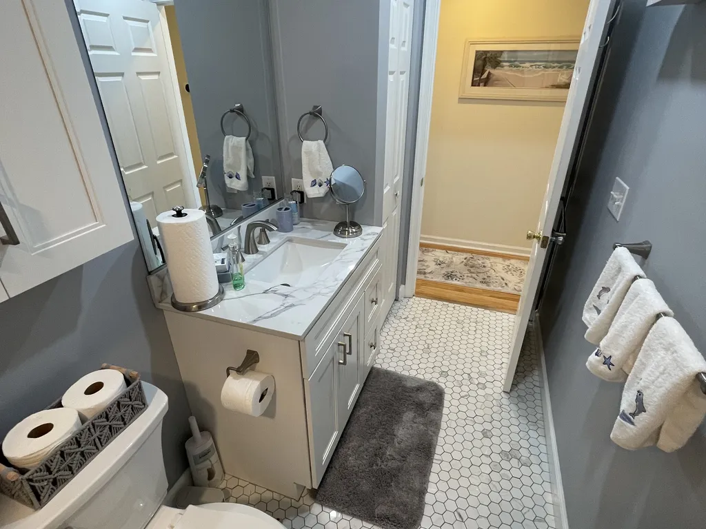 New hall bath with linen closet, walk in tub, and shower 
