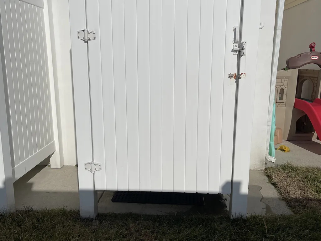 Private enclosed shower w hot and cold shower and hose