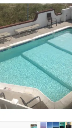 Heated pool and deck overlooking beach
