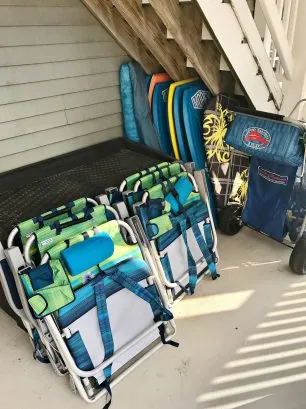 Six BackPack Tommy Bahama Beach Chairs, Two umbrellas, 8 Beach Tags, Numerous Boogie Boards, Various beach toys in brown truck on rear porch, Tommy Bahama Beach Cart to carry it all. 