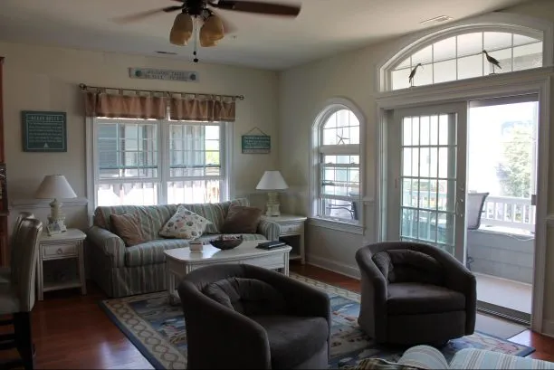 View of Living Room with queen sleeper sofa and the deck.