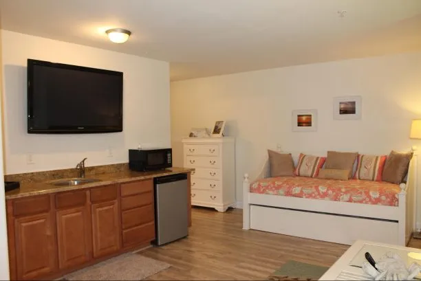 View of wet bar and daybed in first floor master suite.