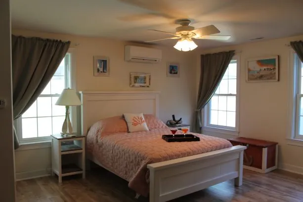 View of queen bed in the first floor master suite.