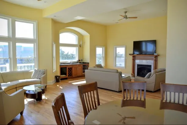 Large family/Living room with wet bar and 12 feet high ceilings gives you feeling of ball room