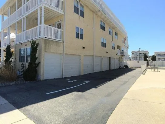 Garages and outside play area. Unit 7 has a private garage next to front door entrance