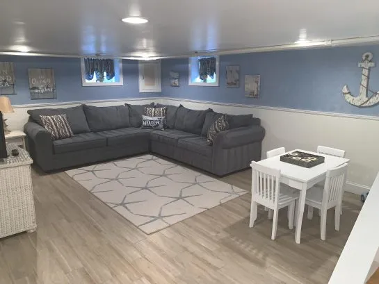 Finished basement with sleeper sofa and kids area