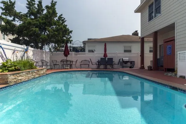 Private fenced in pool with unique outdoor shower