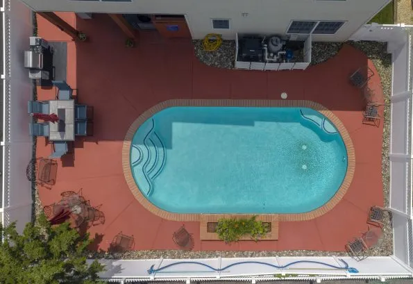 Pool area features grill and ample seating