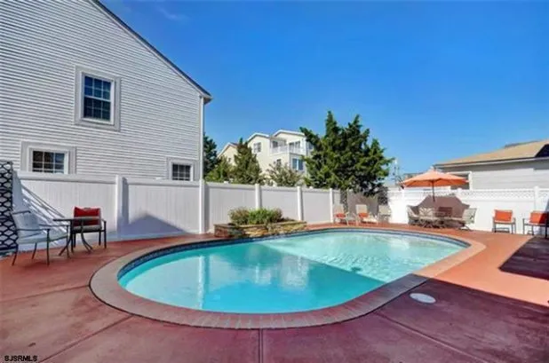 Private pool with waterfall feature and large patio.