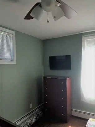 bedroom #2 with TV, ceiling fan and window a/c