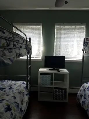 bedroom #3 with TV, ceiling fan and window A/C