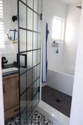 Upstairs shared bath has a wet room (shower and bath) behind one door, and toilet behind another, separated by sink with two faucets to accommodate multiple users