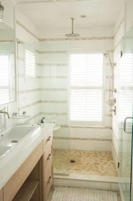 Master bath view from WC area to shower.  Waterproof plantation shutters provide light, water views and privacy.