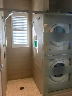 Bedroom 4 en suite bath with shower, and stacking washer dryer.  