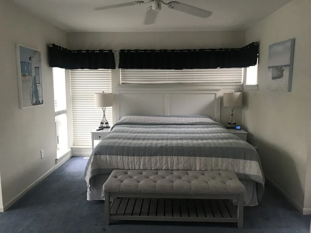 Upstairs king bedroom with tv, ceiling fan, private bath and sitting area