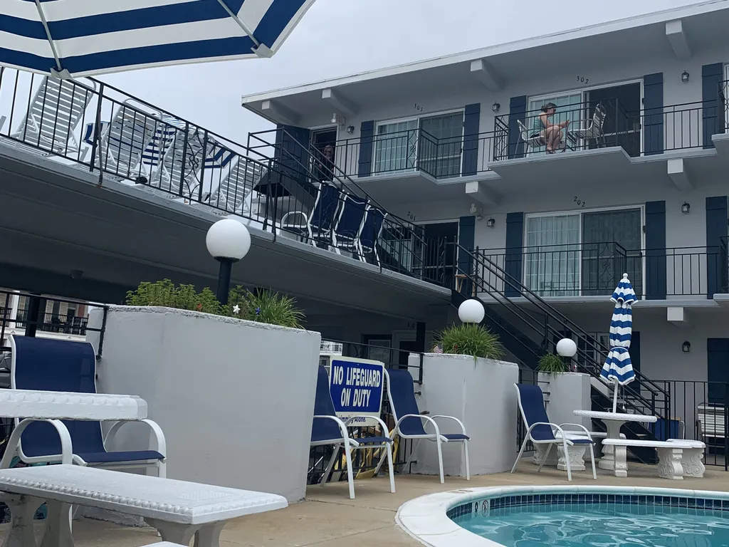 Plenty of pool chairs and tables to eat at around pool