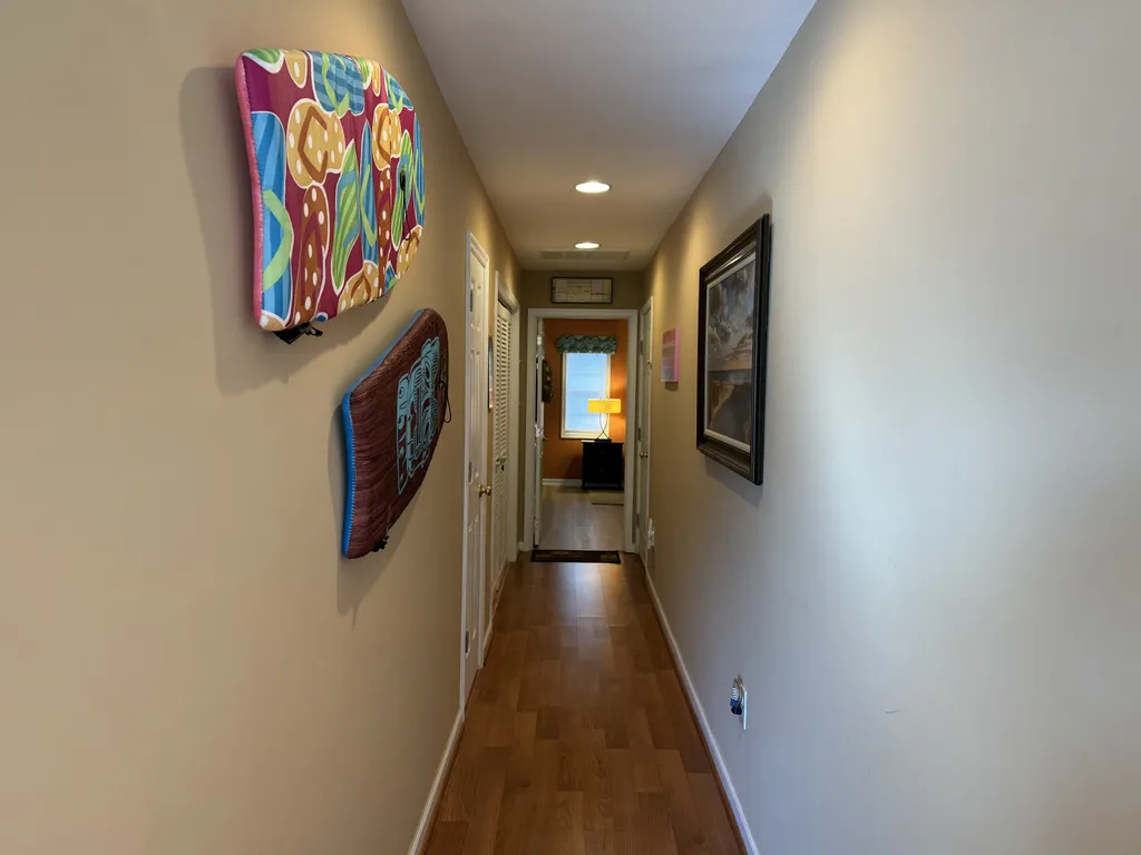 First floor hallway leading to large bedroom and garage entry