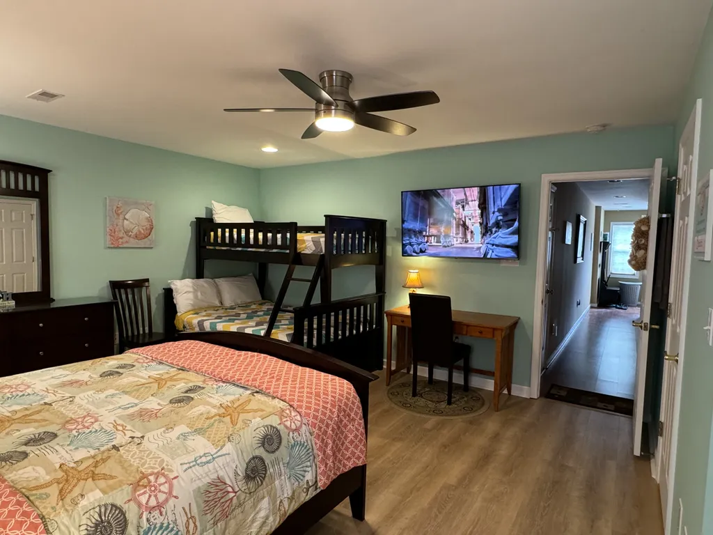 1st floor bunk bed (twin over full) with queen bed and 55&amp;quot; wall-mounted 4K Smart HDTV. 