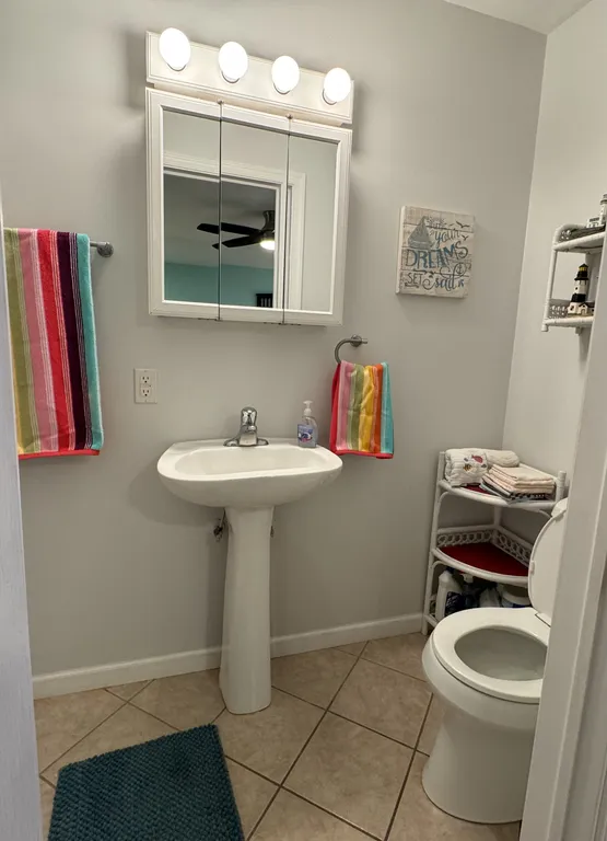 1st floor private full bathroom with pedestal sink, chair-height toilet, and walk-in shower.