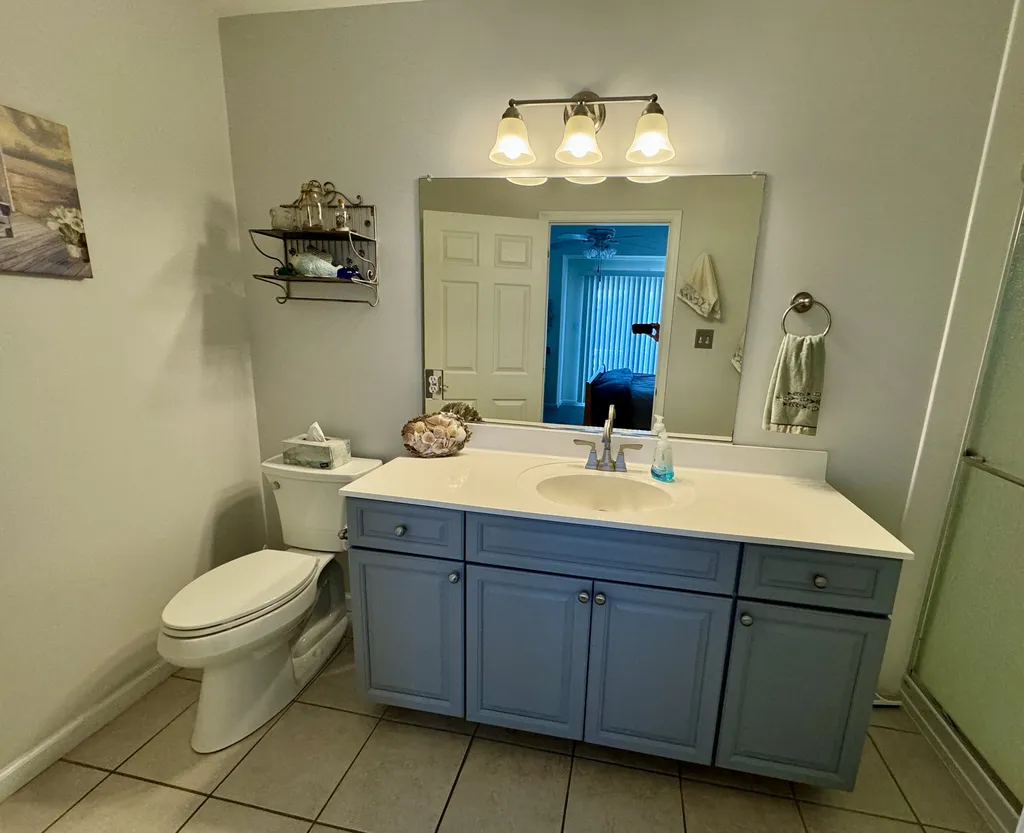 Private Master Bathroom with large vanity/sink, chair-height toilet, and shower