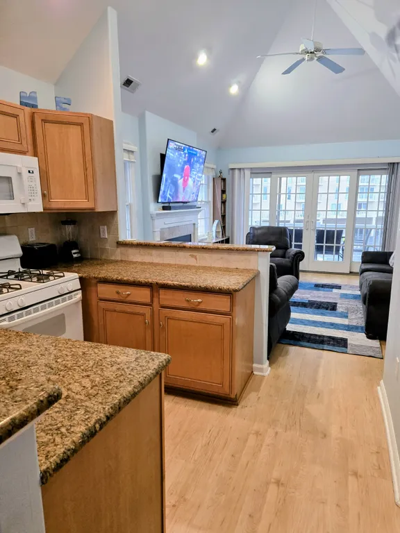 View of kitchen with Living Room in background