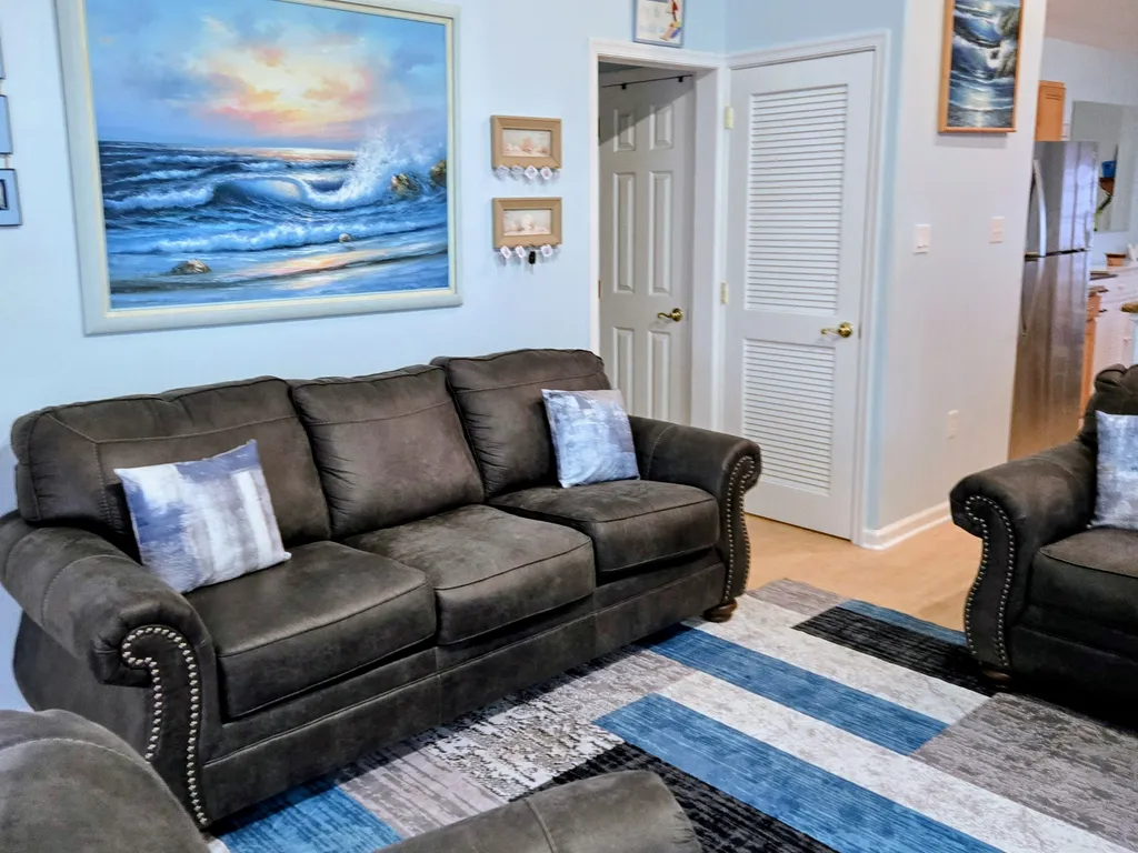 Living Room showing door to washer/dryer unit and cleaning closet