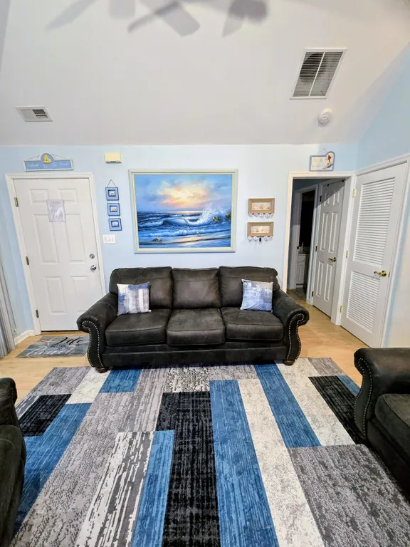 Living Room facing entry door and hallway to bedrooms and bathrooms