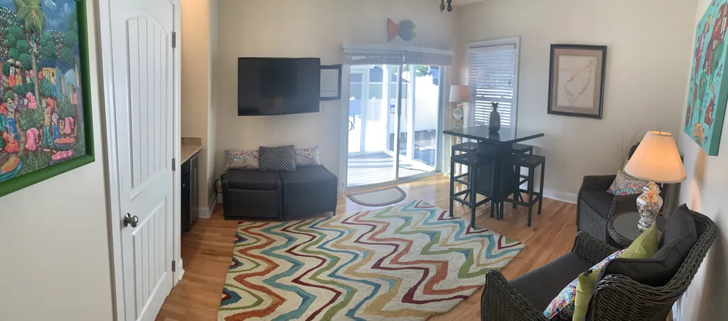 Den leading to porch overlooking pool