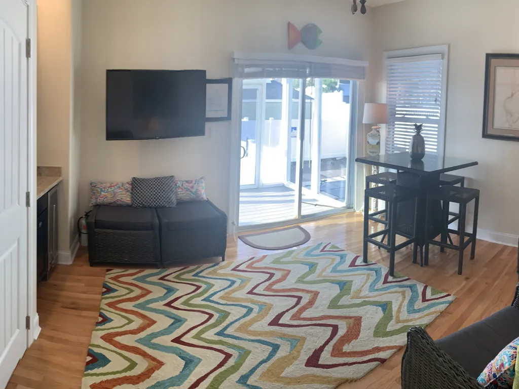 Den leading to porch overlooking pool
