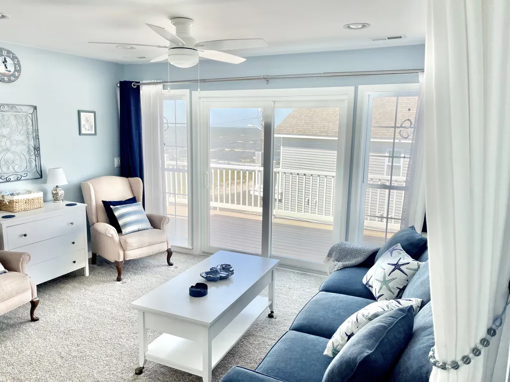 Bedroom #5/sitting room - queen sleeper, dresser, room-dividing drapes, direct deck access and views of beach/bay.