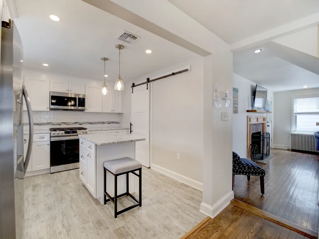 open floor plan with hardwood &amp;amp; tile floors throughout