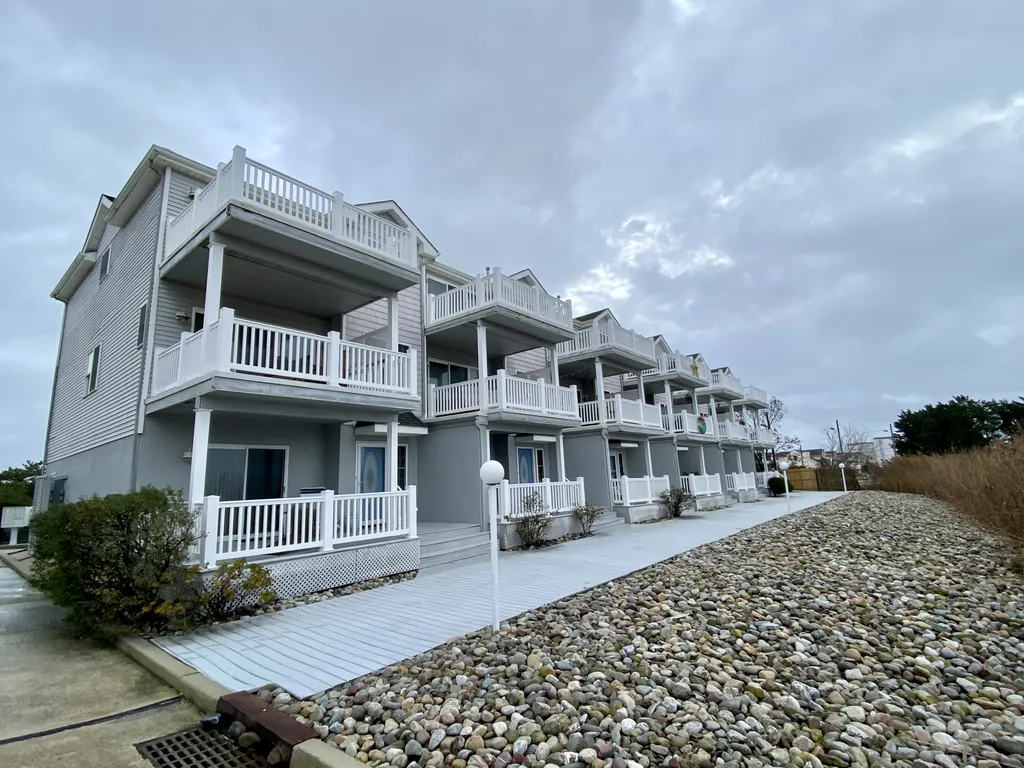 Front of condo featuring 3 private decks 