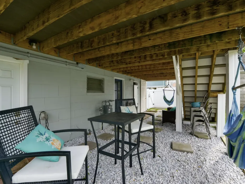 Underneath the back deck, you'll find additional seating, as well as lawn games and the outdoor shower