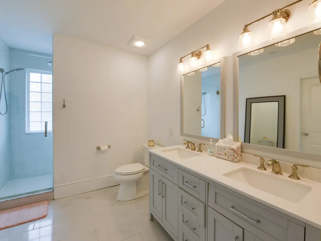 The Primary bathroom features double sinks, a large walk-in shower with dual shower heads, and an expansive walk-in closet