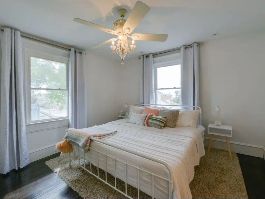 The primary bedroom features a king sized bed