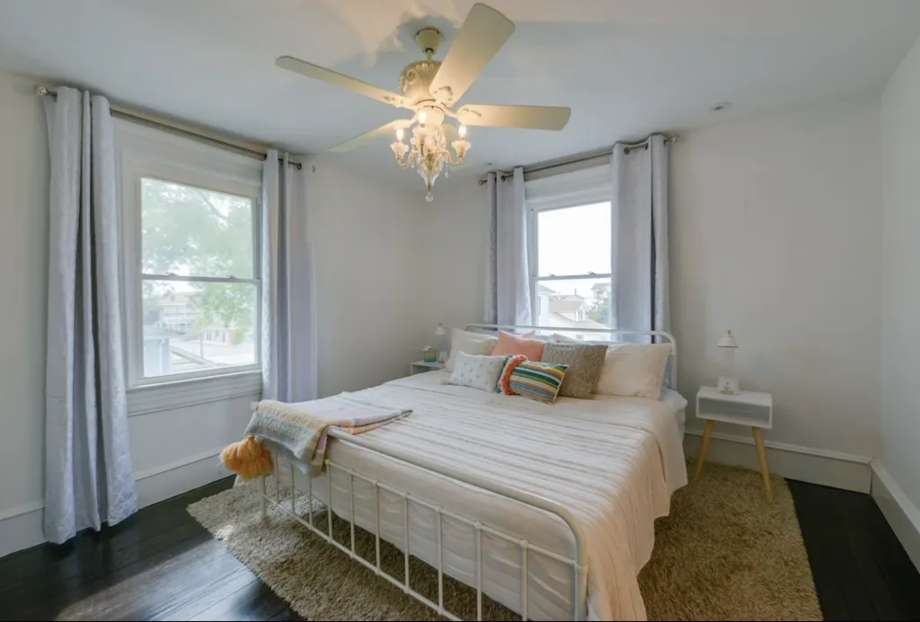 The primary bedroom features a king sized bed