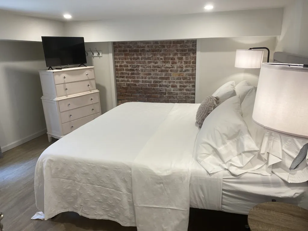 The main bedroom in the apartment has a new king-sized memory foam bed, as well as a smart TV