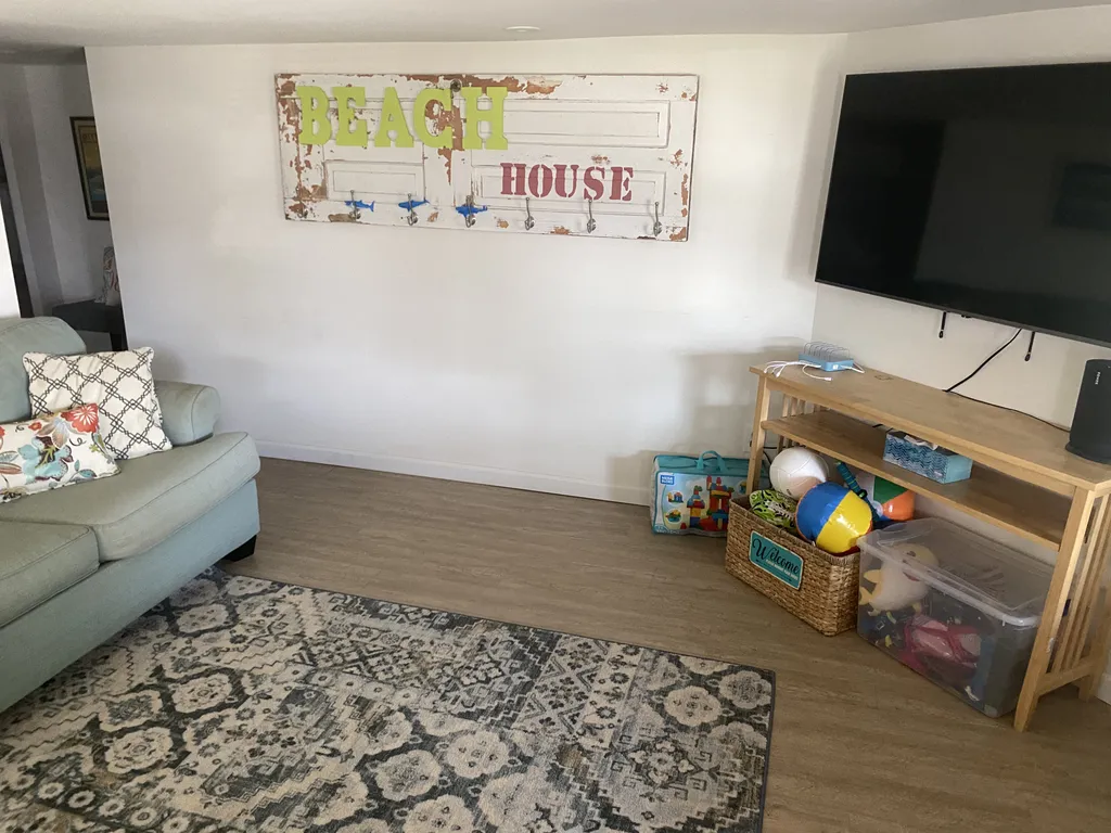 Entering the apartment, you'll find a sitting area with a love seat, a cough (which converts to a queen size sofa sleeper), and a smart TV