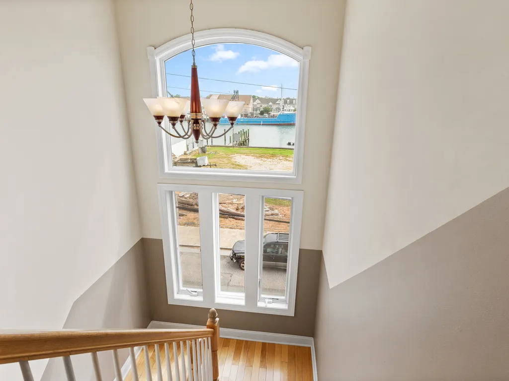 ❤️ The hallway starts at the Elevator and takes you to both Master Bedrooms and to a beautiful staircase on the other side with a unique chandelier and great water views! You will love it!