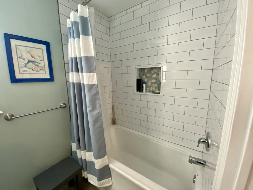 Full bath with large tiled tub/ shower.