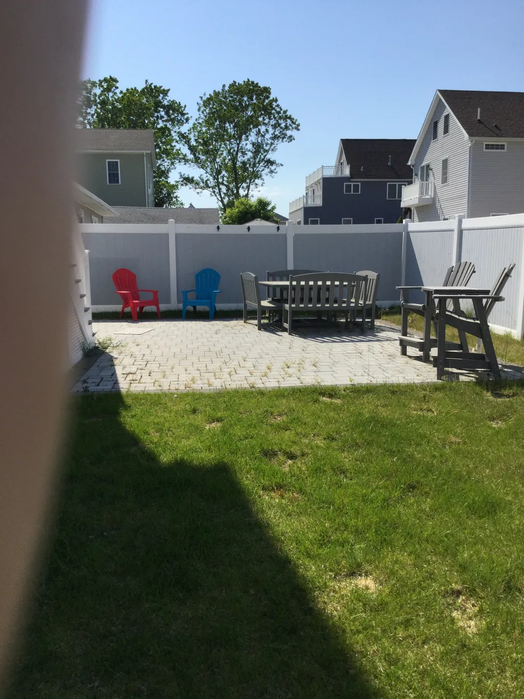 Sunny backyard with outdoor dining space &amp;amp; outdoor shower